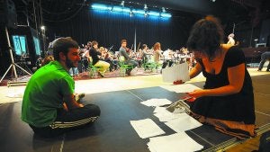 Colaboración. Una de las violinistas de la orquesta rebusca entre las partituras antes del ensayo general junto a uno de los bailarines de Aukeran. ::
FÉLIX MORQUECHO/