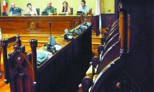 Alcalde y concejales de Bildu al fondo con los asientos de los ediles de la oposición vacíos en primer plano. ::
JUANFER/
