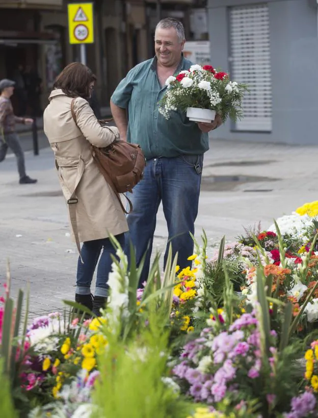 Una ciudadana compra flores en el puesto de Genaro Etxeandia./