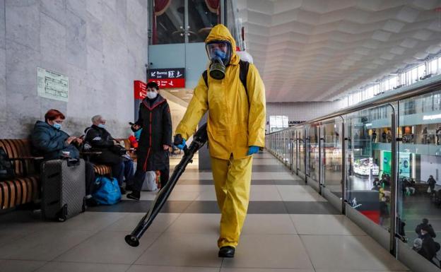 An employee performs disinfection work at the Leningradsky Station in Moscow.