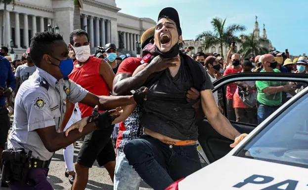 A man is arrested during a protest against Cuban President Miguel Díaz-Canel in Havana.