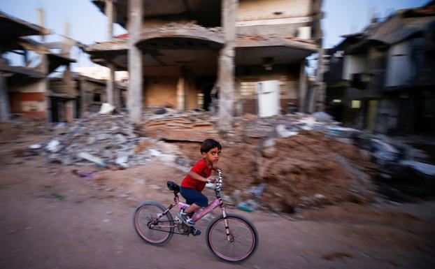 A child cycling through the streets of Gaza. 