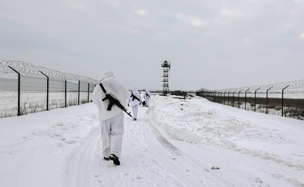 Ukrainian border guards patrol a border between Ukraine and Russia.