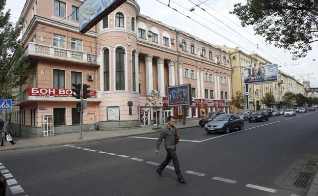 A passer-by crosses a street in the center of Donetsk (Ukraine).