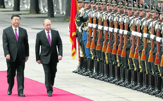 Chinese President Xi Jinping receives his Russian counterpart Vladimir Putin with military honors in Beijing. 