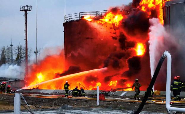 Firefighters try to put out the fire after a Russian long-range missile hit a fuel depot in Lviv. 