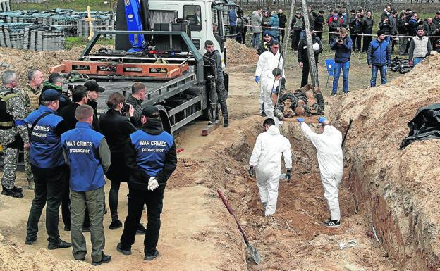 Exhumation of bodies of murdered civilians in a mass grave in Bucha.