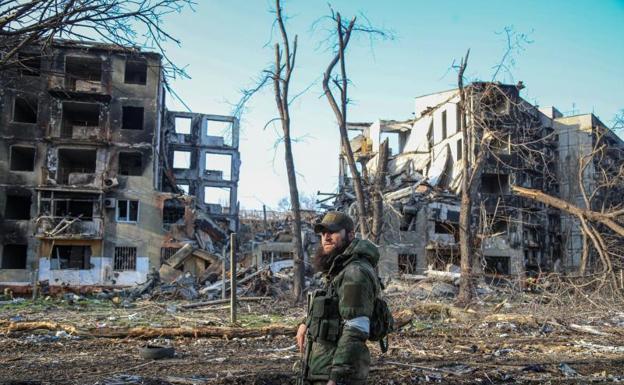 A soldier walks through the rubble of the city of Mariupol. 