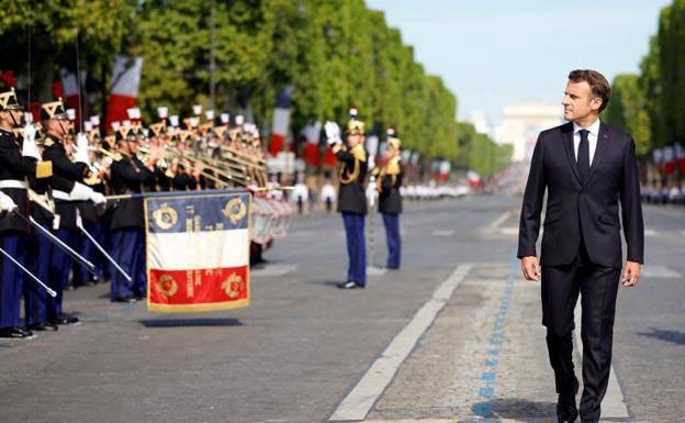 Macron reviews the troops during the celebration of the French national holiday. 