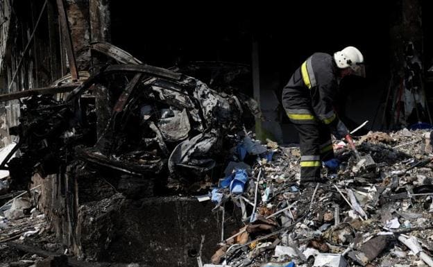 A member of the emergency teams examines the rubble of the bombed-out building in Vinnitsa. 