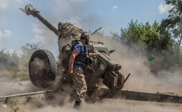 A Ukrainian soldier fires a howitzer near a front line in Mykolaiv. 