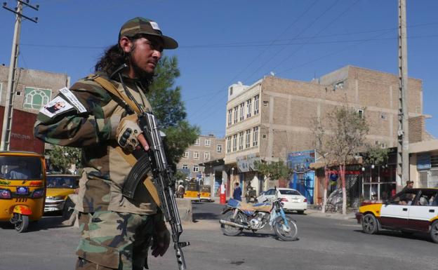 A member of the Taliban security teams guards a street in Herat after the attack. 