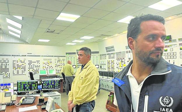 One of the IAEA experts inspects the control room of the nuclear power plant.