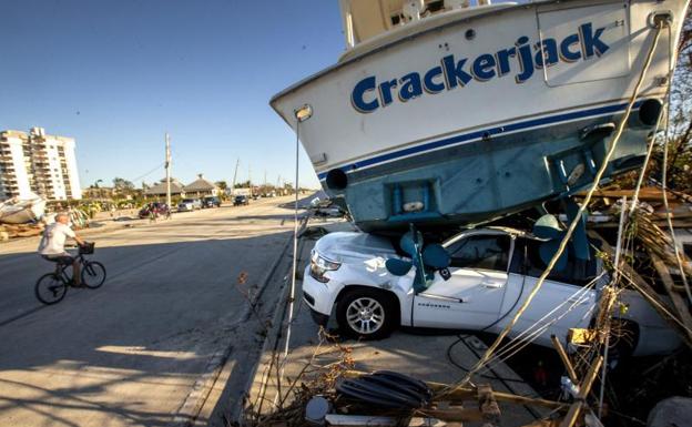 A boat sits on top of a car in Fort Myers, Florida. 