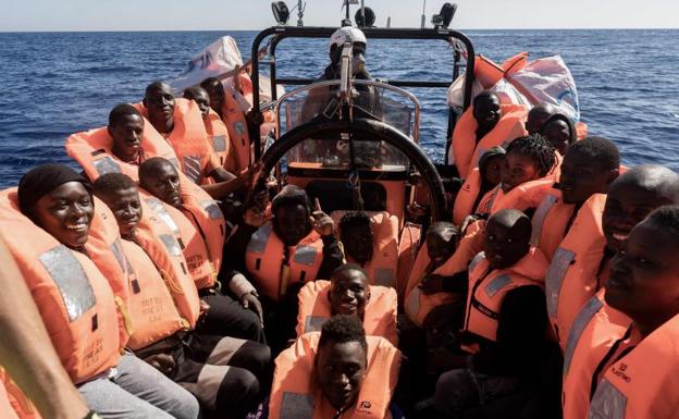 Migrants rescued in the Mediterranean prepare to board the Ocean Viking