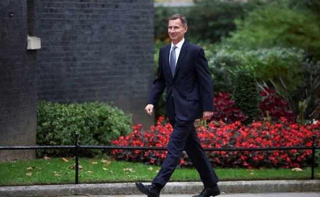 Jeremy Hunt walks on the outskirts of Downing Street.