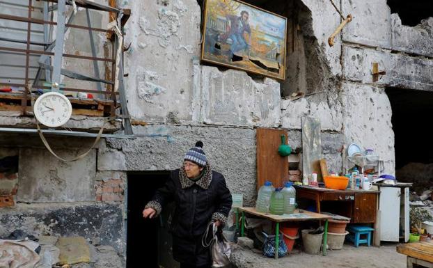 A civilian emerges from a basement converted into a bunker in Mariupol.