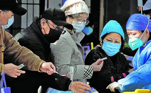 Nurses perform PCR tests on patients at the entrance of a hospital in Shanghai, China. 